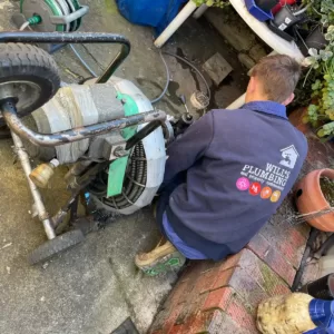plumber-unblocking-a-drain-using-machine