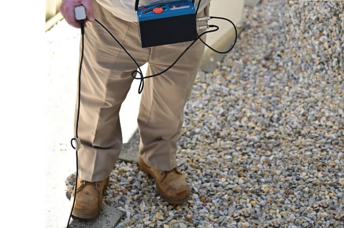 person-using-acoustic-leak-detectors