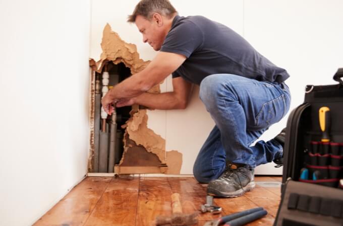 plumber-fixing-pipe-in-wall